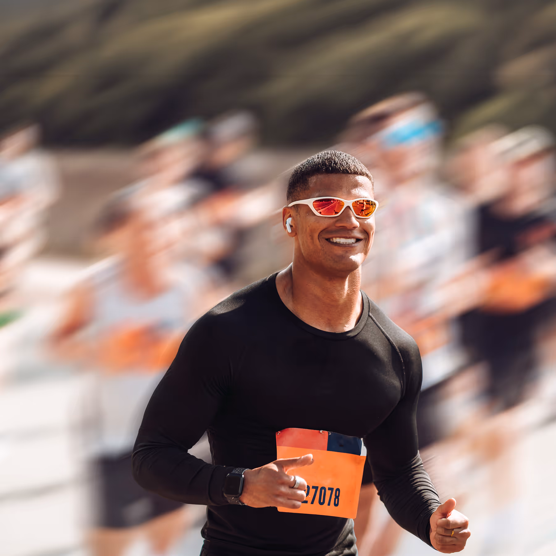Male runner is pictured smiling taking part in a running event
